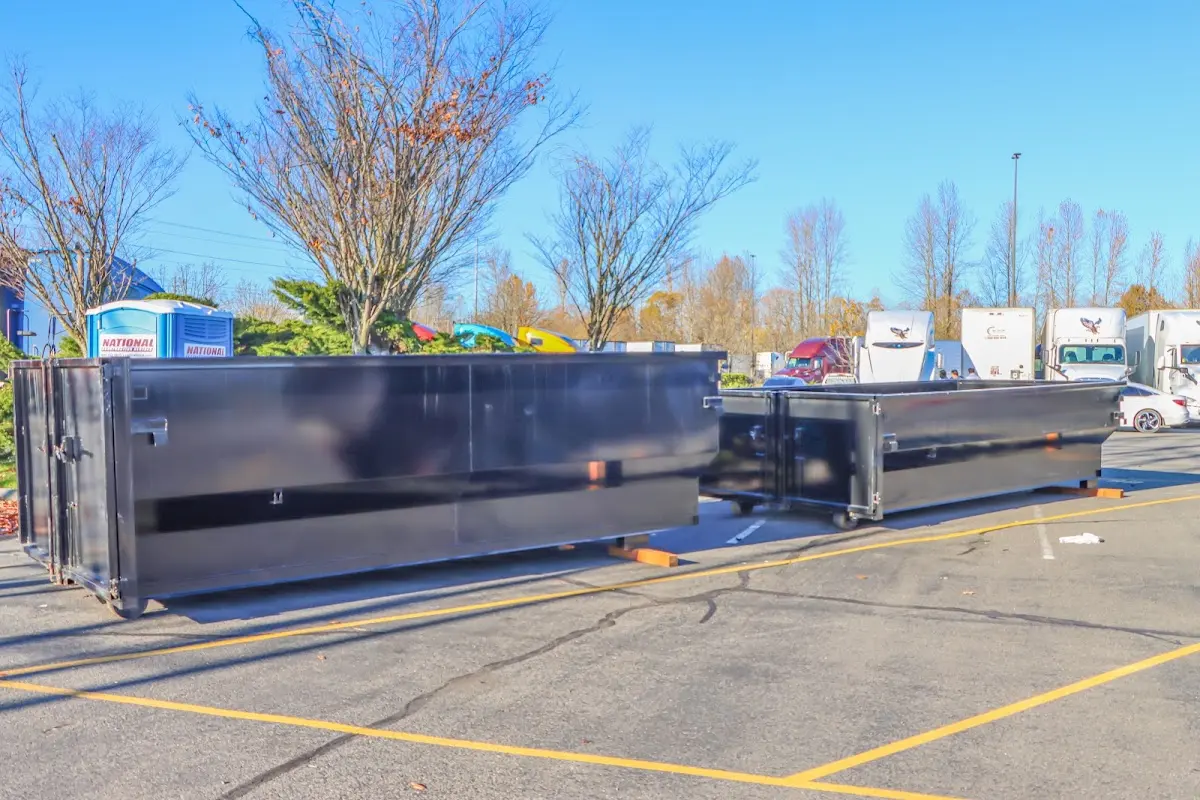 Professional dumpster rental service with roll-off container on residential driveway in El Centro